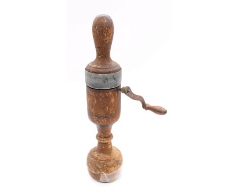 A late Victorian medical vibrator, made from turned wood with a metal handle, item rotates when the handle is turned and the 