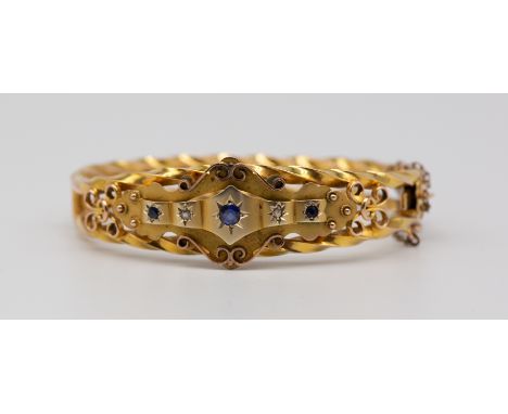 A late19th century sapphire and diamond set 9ct gold bangle, comprising star set round mixed cut sapphires and small rose cut