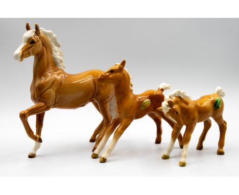 A Beswick Palamino Horse 'Prancing Arab' model number 1261 &amp; 3 Beswick Palamino foals , together with 3 other beswick Foa