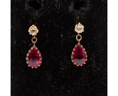 A pair of antique ruby (probably synthetic) and white sapphire tear drop screw back earrings in yellow metal mounts, in fitte