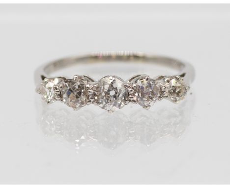 A diamond and platinum set ring, comprising five graduated old cut diamonds, total diamond weight approx 0.70ct, claw set in 