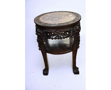 A late 19th Century/early 20th Century Chinese hardwood vase stand with rouge marble insert, pierced apron lower shelf suppor