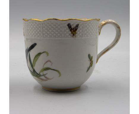 A Meissen teacup painted with a bird and insects with ozier moulding and a gilded scalloped top rim.Early 19th centuryDiamete