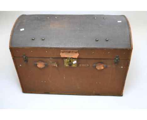 An early 20th Century dome topped travel trunk, with travel labels/stickers to sides.