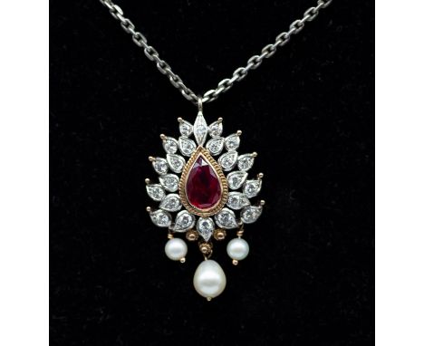 A ruby, diamond and pearl Indian style pendant, comprising a pear cut ruby, weighing approx 1.80carats, within an ornate diam