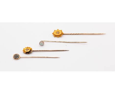 A collection of four gold stick pins to include a Victorian diamond set 15ct gold pin, along with another similar unmarked pi