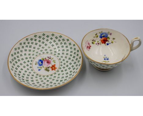 Probably Swansea tea cup and saucer with gilded rim to the cup and saucer the cup is painted with tiny green petals on the ou