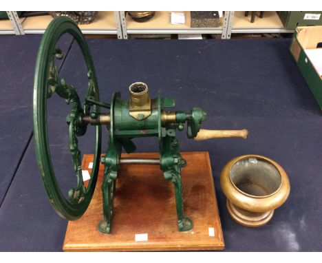 A large cast iron coffee grinder by Parnell &amp; Sons on oak stand, green in colour with makers name on wheel.