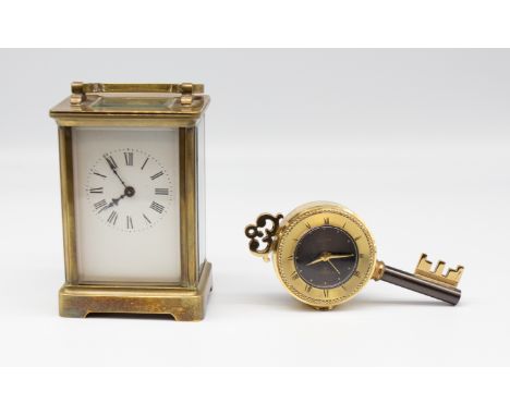 An early 20th Century French brass carriage clock along with a late 20th Century key shaped clock.