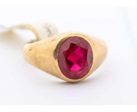 A synthetic ruby and 9ct gold ring, set with an oval synthetic ruby, width approx 13mm, size V, total gross weight approx 9gm