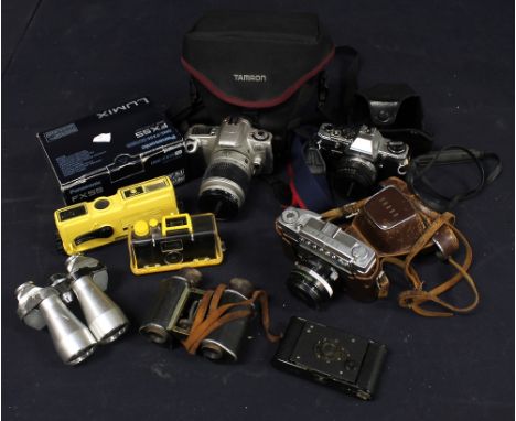 A collection of vintage cameras and binoculars to include: Minolta, Taron, Canon, Nettar with residual films and lenses (1 bo