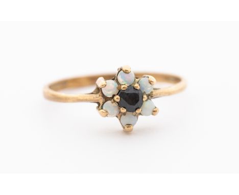 An opal and sapphire 9ct gold flower cluster ring, setting approx 7mm, size O, total gross weight approx 1.3gms    Further de