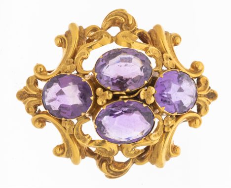 A Victorian amethyst and gold brooch, comprising four oval mixed cut amethysts within a border of embossed gold scrolled deco