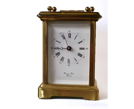 A 20th century Bornand Freres brass cased carriage clock with key, glass panelled sides and door to back (no knob on back doo