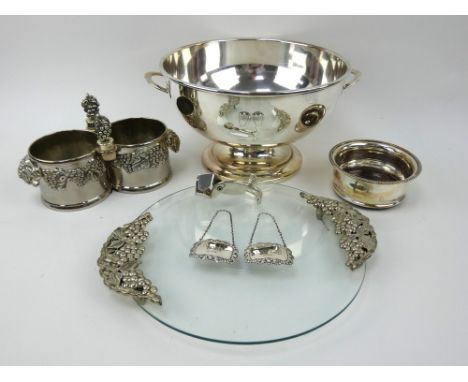 Two silver decanter labels, a silver plated punch bowl, wine coasters, bottle holder, ice tongs and a glass cheese board with