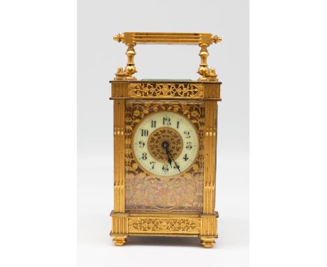 A late 19th/early 20th century probably Continental gilt brass filigree cased carriage clock, no makers mark, with stylised n