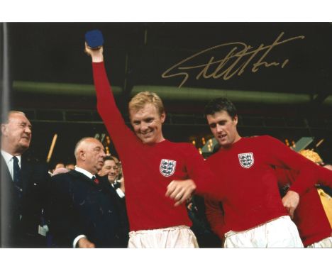 Geoff Hurst signed 12 x 8 inch colour 1966 World Cup final football photo, standing next to Bobby Moore. Good Condition.  All