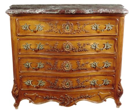 A walnut commode in Louis XV style, the marble top with a moulded edge above four long drawers with applied leaf and flower c