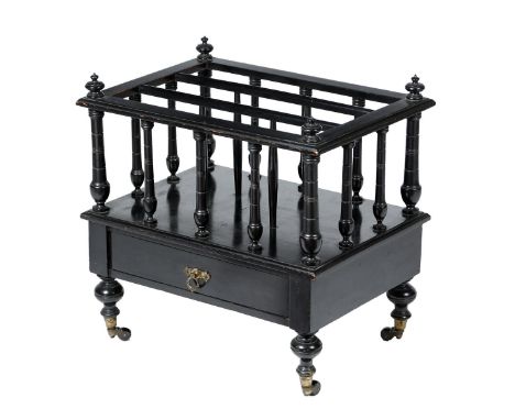 A late Victorian ebonised Canterbury, with three divisions above a drawer, on ceramic castors, 52.8cm high, 52.4cm wide, 37.7