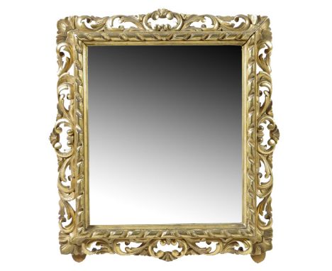 A late 19th century Italian Florentine giltwood wall mirror, with a rectangular plate within a leaf and scroll carved frame, 
