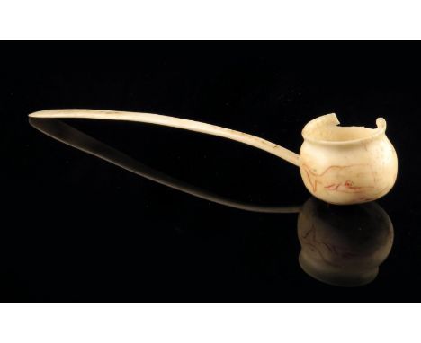 A sailor's whale bone rum toddy ladle, the bowl scrimshaw decorated in red with a whale and inscribed 'Whale Ship DIANA GREEN