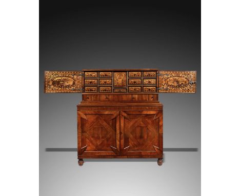 λ An 18th century German kingwood and rosewood table cabinet, oyster veneered, with a pair of doors enclosing an interior inl