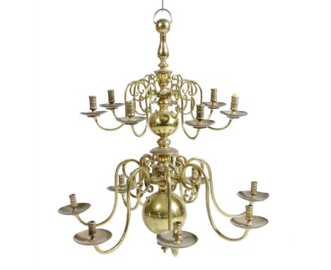 A pair of George I style brass fourteen light chandeliers, each with a baluster ball cut and disk turned shaft issuing scroll