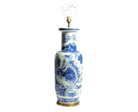 A Chinese porcelain blue and white table lamp, decorated with deer and cranes in a watery landscape with pine trees, with bra