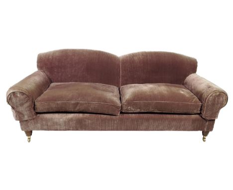 A modern two seater sofa, upholstered with plush fabric on turned beechwood front legs and brass castors, 213cm wide, 86.7cm 