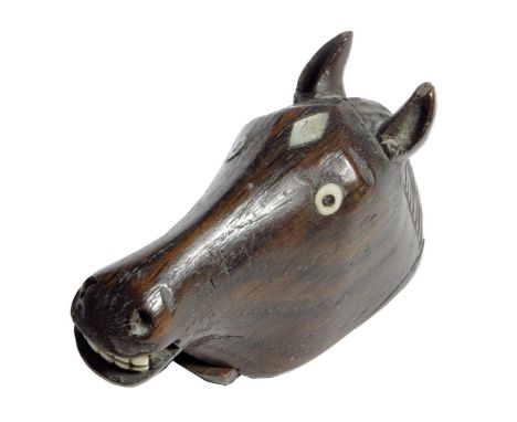 A 19th century treen snuff box, in the form of a horse's head, with mother of pearl and bone inlay and with brass tack decora