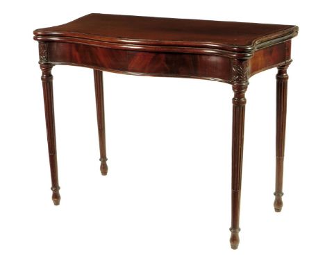 A George III mahogany serpentine card table, the crossbanded top inlaid with stringing, revealing a baize lined surface on tw