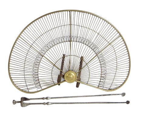 A pair of George III steel fire tongs, with a turned finial and baluster stems, together with a brass wirework fan shaped fir
