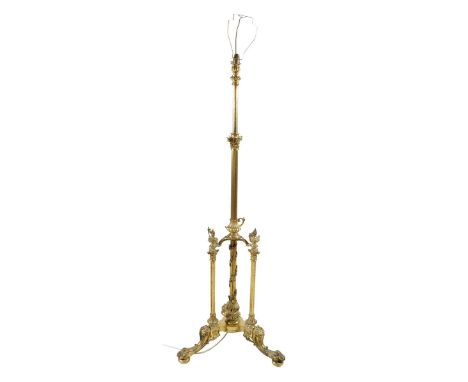 A late Victorian gilt brass Corinthian column standard lamp, with fluted stems, the elaborate base with three flaming oil lam