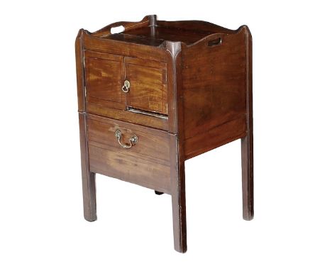 A George III mahogany tray-top bedside commode, with a pair of pierced handgrips with a cupboard above a pull-out converted b