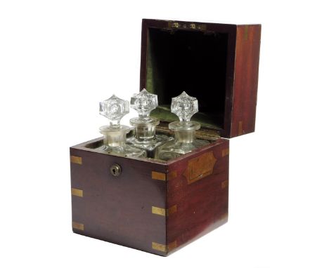 A 19th century mahogany and brass travelling decanter case, the hinged lid with a vacant plaque, revealing a plush lined inte