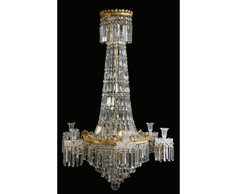 A Regency gilt brass and cut glass chandelier, with a foliate corona hung with faceted drops and lustres above a tapering ste