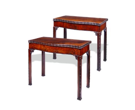 A near pair of George III mahogany serpentine card tables, each with a hinged top with a floret carved edge revealing a baize
