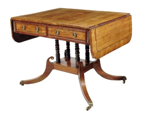 A Regency kingwood and brass mounted sofa table, the drop-leaf crossbanded top above a pair of frieze drawers with false fron