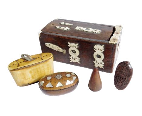 An oak and fruitwood box, with a sliding cover revealing an interior lined with 19th century newspaper, with applied bone mou