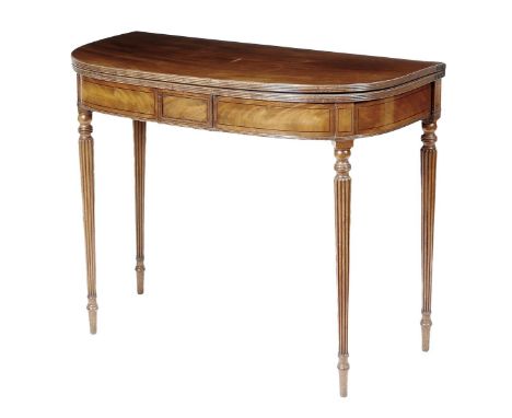 A George IV mahogany card table, inlaid with ebonised stringing, the 'D' shaped top with a reeded edge on ribbed tapering leg