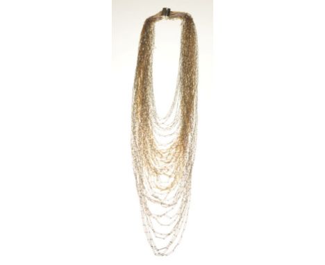 Christian Dior: A 1968 bi-coloured strand waterfall necklace
Comprised of graduated gold and silver tone chains, signed Chris