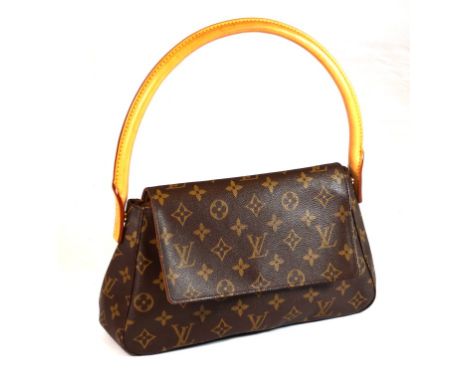 A Louis Vuitton monogram 'Mini Looping' handbag
The tapered classic design bag, with foldover flap revealing canvas lining wi