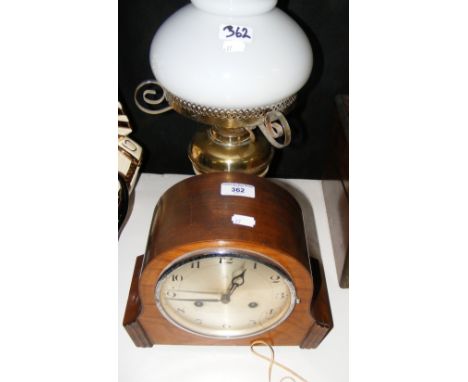 A mantel clock, together with an oil lamp