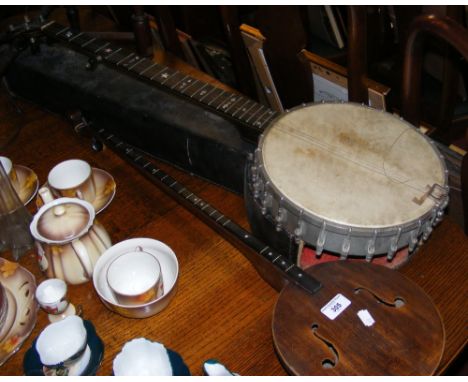 A cased banjo, together with one other string instrument