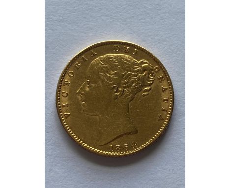 A Queen Victoria Sovereign, Young head l. reverse Shield with die number, dated 1864.  *CR:  Light surface marks and rubbing.