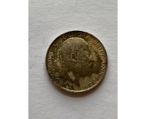 An Edward VII Shilling, bare head r, lion passant on crown, dated 1910.  *CR:  Good condition with attractive light toning.  