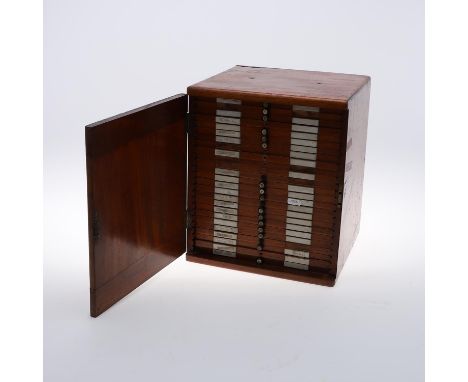 A Victorian Mahogany coin collectors cabinet with a single door, containing twenty five lined trays, some with division. Cont