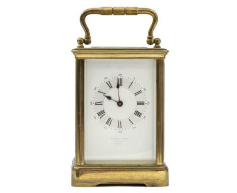 An eight day French brass carriage clock, the white enamel dial with Roman numerals, and inscribed Howell & James, London.