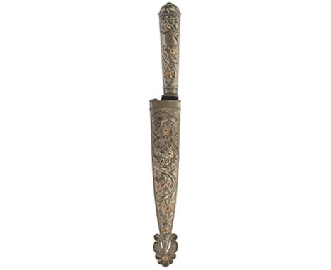 A South American Gaucho knife, 16cm blade with faceted back edge and stamped with a maker's panel PAMPA (?), white metal hilt