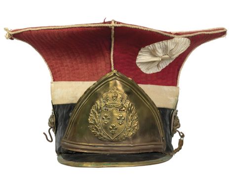 A reproduction French Napoleonic style Chapska, brass mounted black leather trimmed body with red felt top, embossed brass he